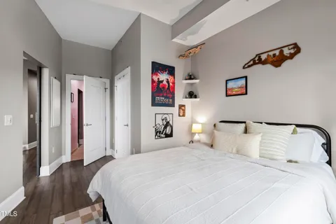 a bedroom with bed and a night stand