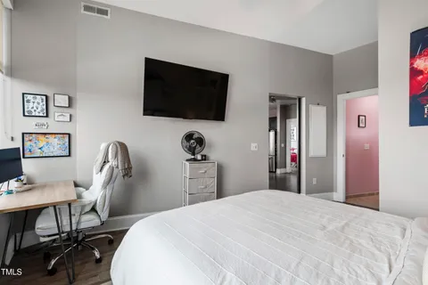 a bedroom with a bed and a flat screen tv