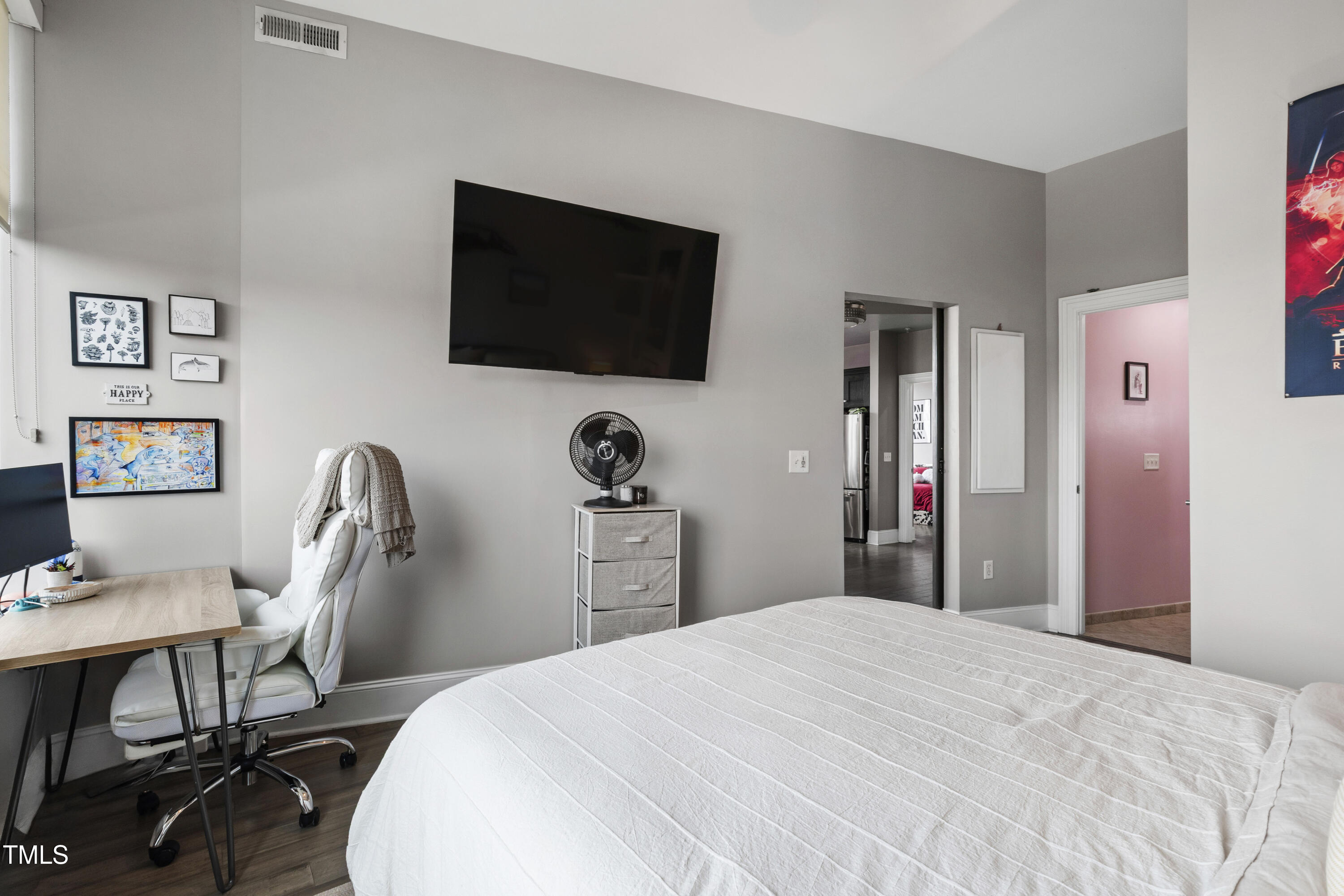 400 West North Street, Unit 610 Raleigh, NC 27603 - Photo 18 of 43 a bedroom with a bed and a flat screen tv