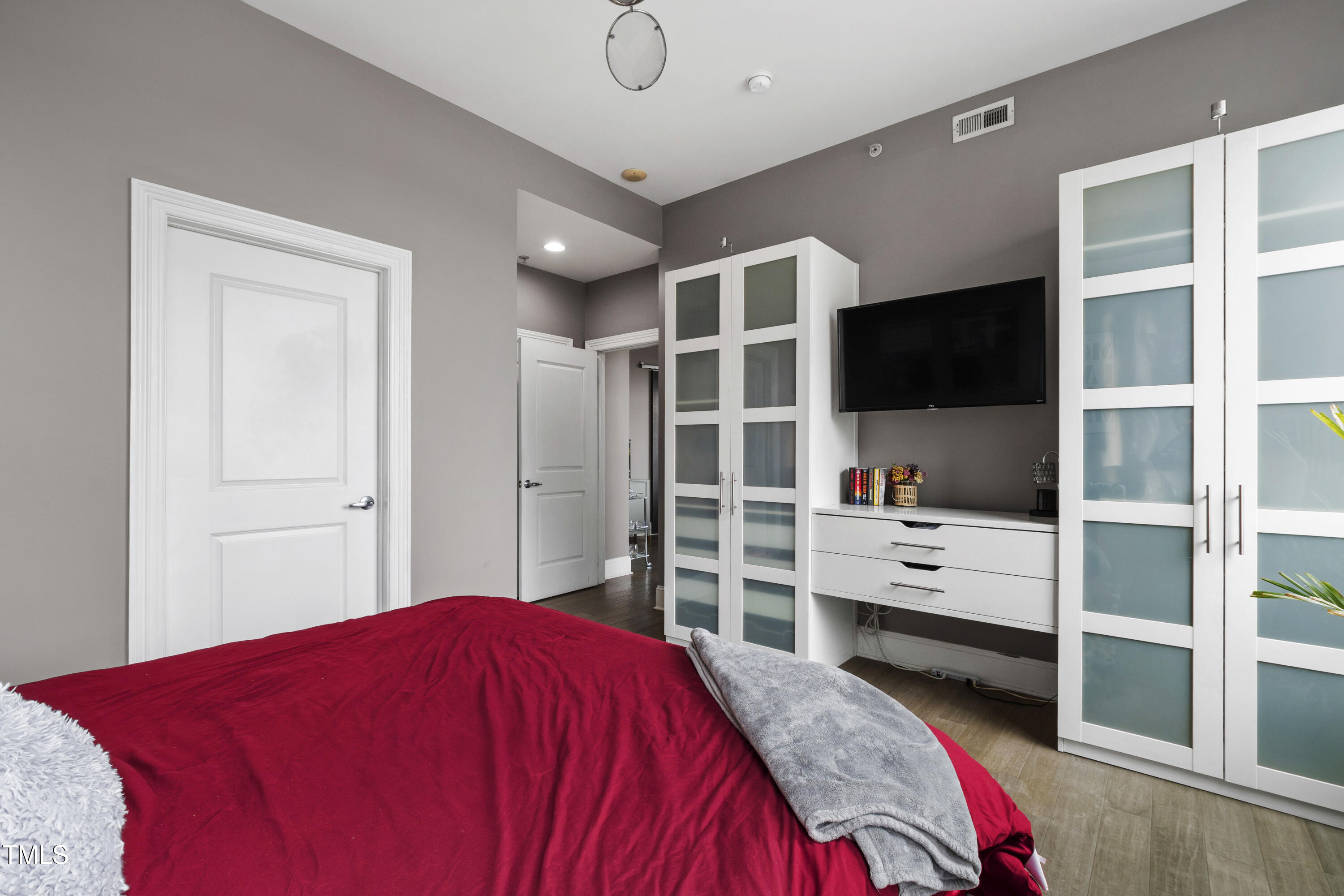 400 West North Street, Unit 610 Raleigh, NC 27603 - Photo 24 of 43 a bedroom with a bed and a flat screen tv