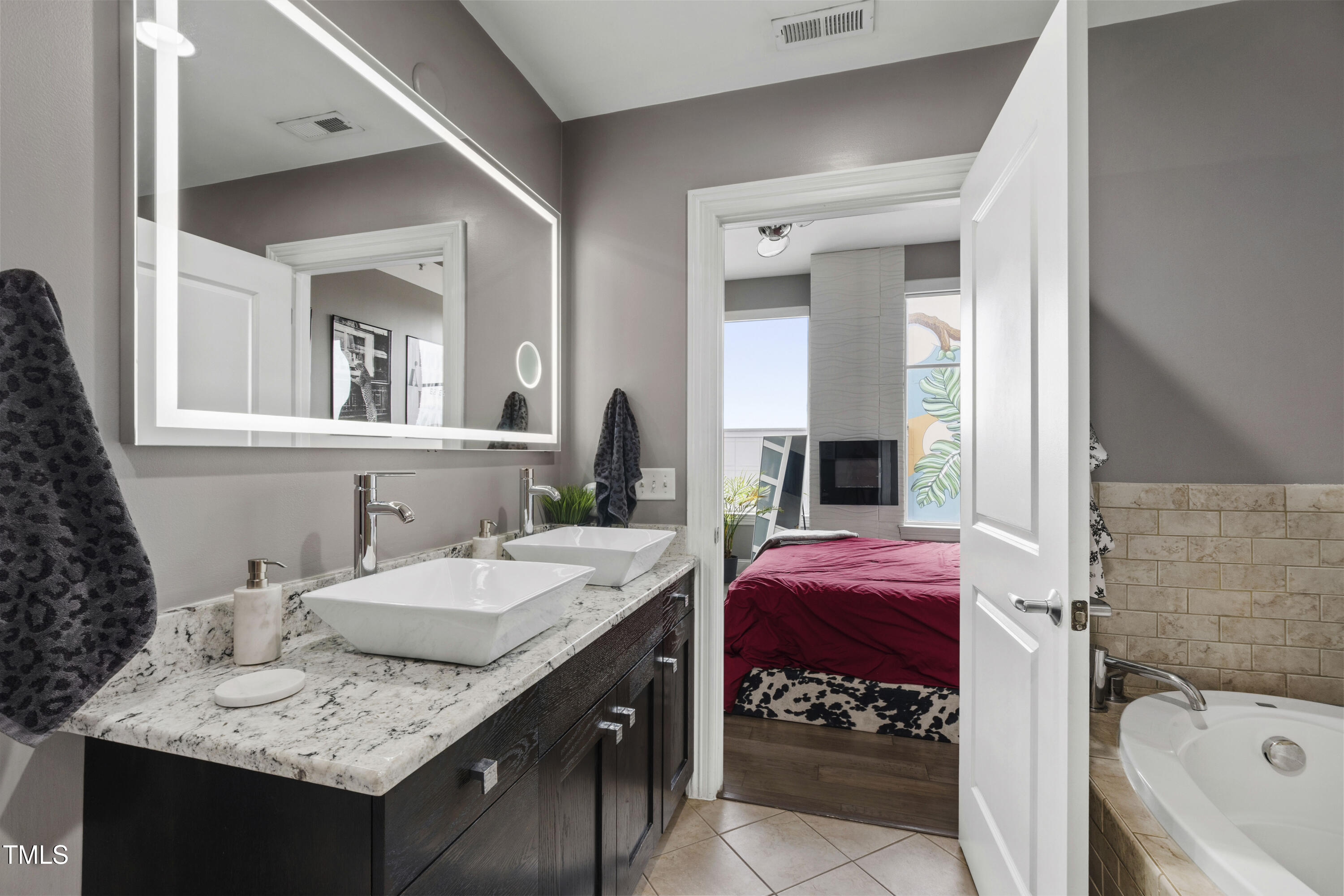400 West North Street, Unit 610 Raleigh, NC 27603 - Photo 25 of 43 a en suite bathroom with a granite countertop tub and a sink