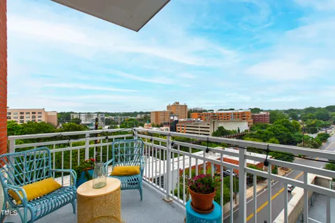 a view of a balcony with outdoor seating