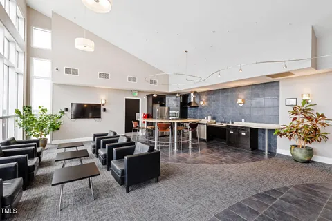 a living room with furniture a fireplace and a potted plant