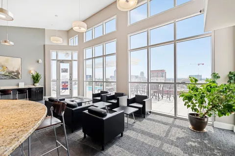 a living room filled with furniture and a potted plant