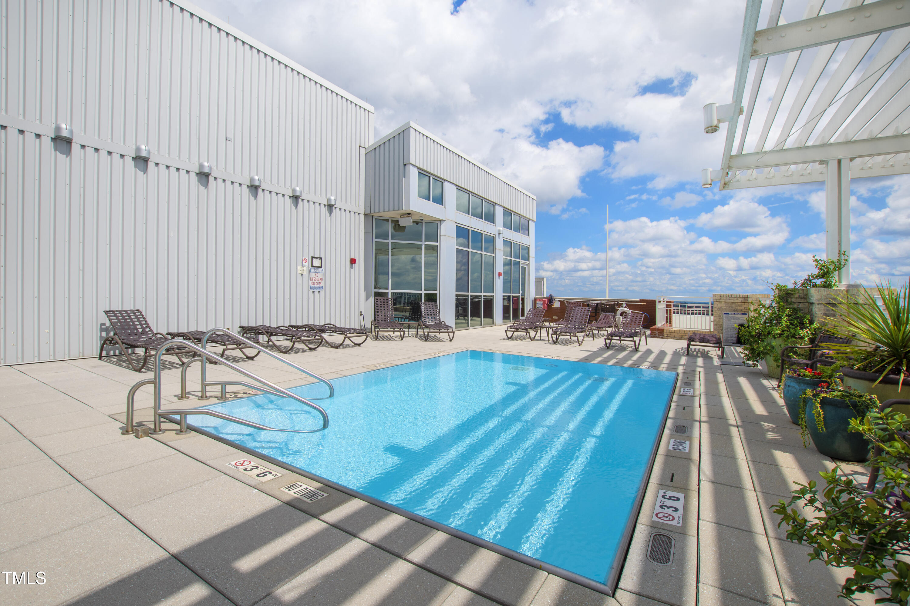400 West North Street, Unit 610 Raleigh, NC 27603 - Photo 36 of 43 a view of a balcony with chairs and wooden floor