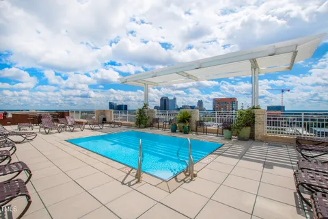 a view of a terrace with lawn chairs