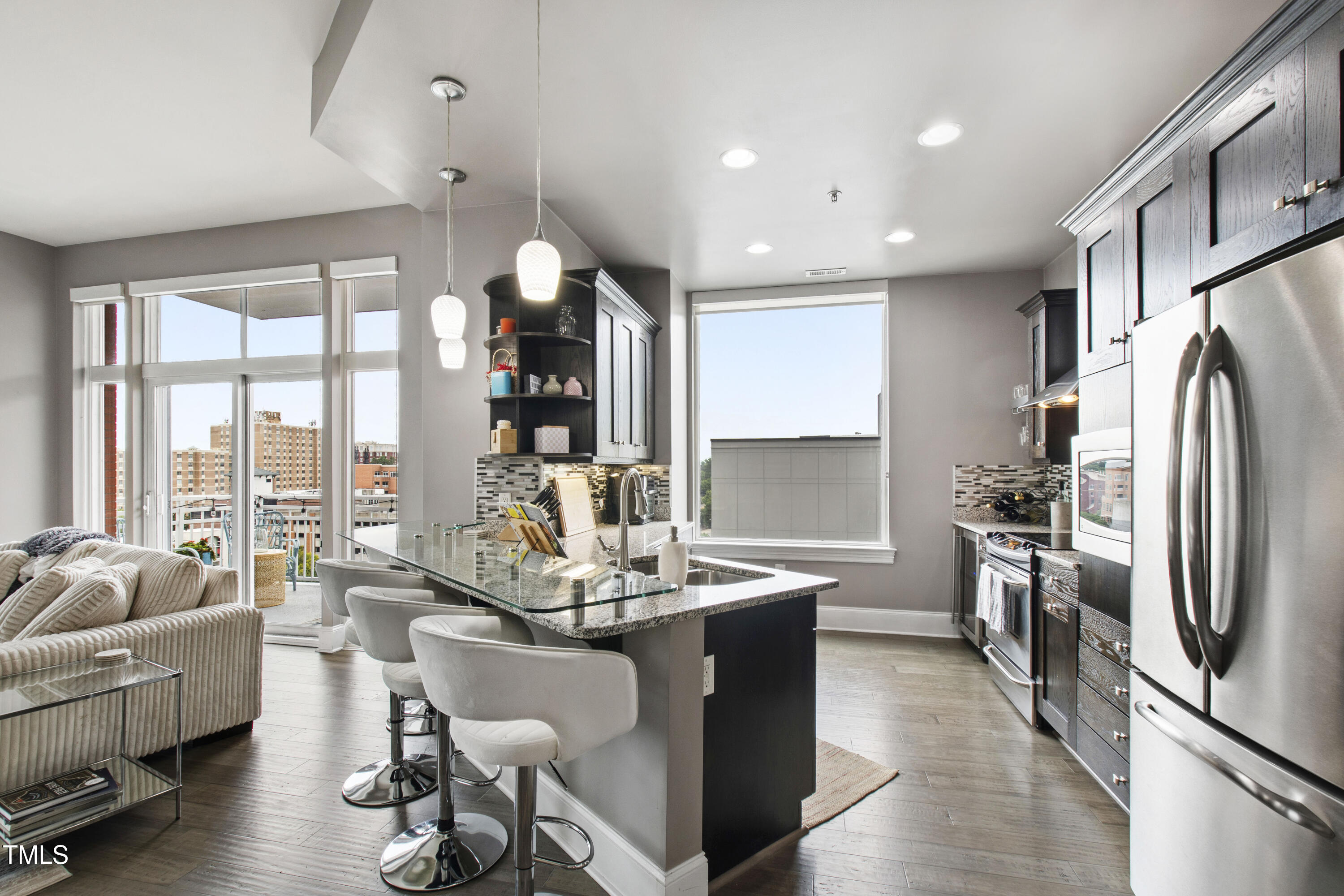 400 West North Street, Unit 610 Raleigh, NC 27603 - Photo 5 of 43 a kitchen with stainless steel appliances granite countertop a refrigerator and a stove top oven