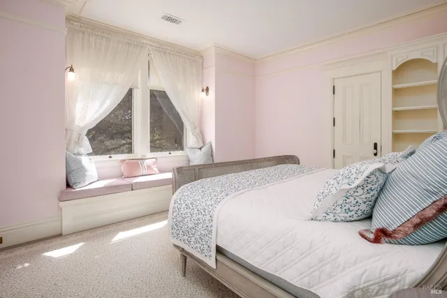 a living room with furniture a window and wooden floor