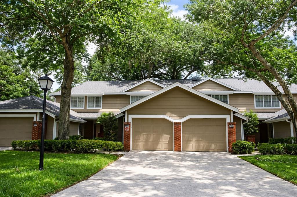 672 Post Oak Circle, Unit 106 Altamonte Springs, FL 32701 - Photo 1 of 21 a front view of a house with a garden and yard
