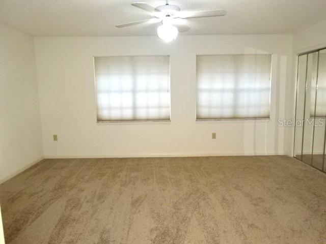 672 Post Oak Circle, Unit 106 Altamonte Springs, FL 32701 - Photo 15 of 21 an empty room with windows and fan
