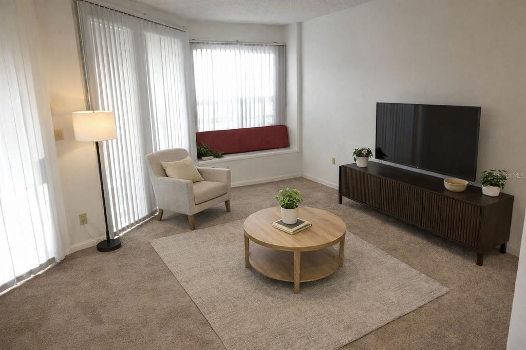 672 Post Oak Circle, Unit 106 Altamonte Springs, FL 32701 - Photo 2 of 21 a living room with furniture and a flat screen tv