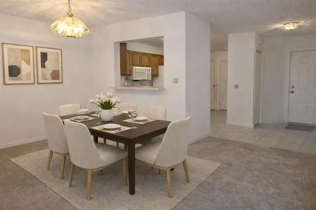 672 Post Oak Circle, Unit 106 Altamonte Springs, FL 32701 - Photo 4 of 21 a view of a dining room with furniture and a chandelier