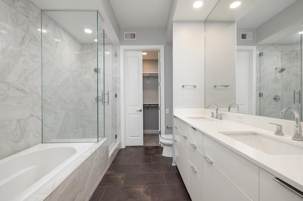 717 Riverside Drive, Unit 1105 Memphis, TN 38103 - Photo 16 of 29 Full bathroom featuring double vanity, a stall shower, recessed lighting, a garden tub, and a walk in closet