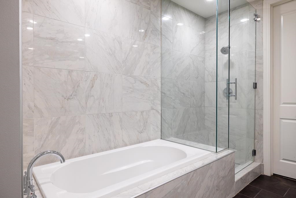 717 Riverside Drive, Unit 1105 Memphis, TN 38103 - Photo 17 of 29 Bathroom with a bath and a marble finish shower