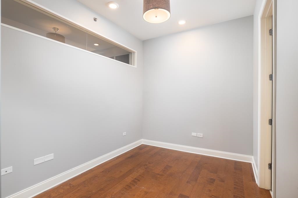 717 Riverside Drive, Unit 1105 Memphis, TN 38103 - Photo 20 of 29 Unfurnished room with dark wood finished floors and recessed lighting
