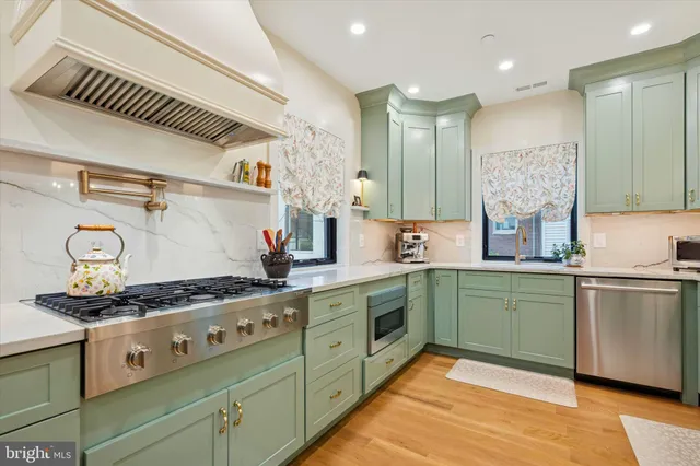 a kitchen with stainless steel appliances granite countertop a stove and a sink