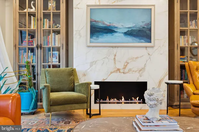 a living room with furniture and a floor to ceiling window