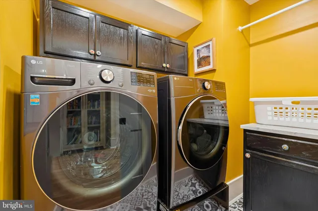 a view of a couches and dinning table with a potted plant