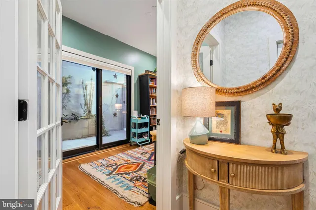 a bathroom with a granite countertop sink and a toilet