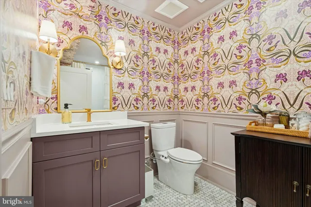a front view of a house with potted plants