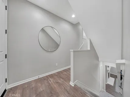 an entryway in a room with wooden floor
