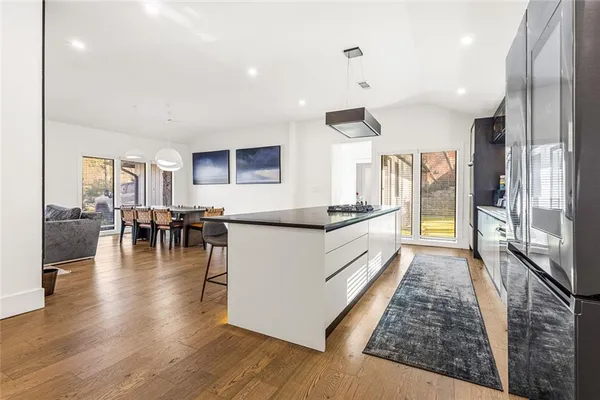 a living room with furniture or kitchen view and a wooden floor