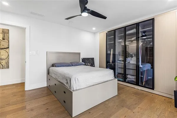 a view of walk in closet with clothes and shoes