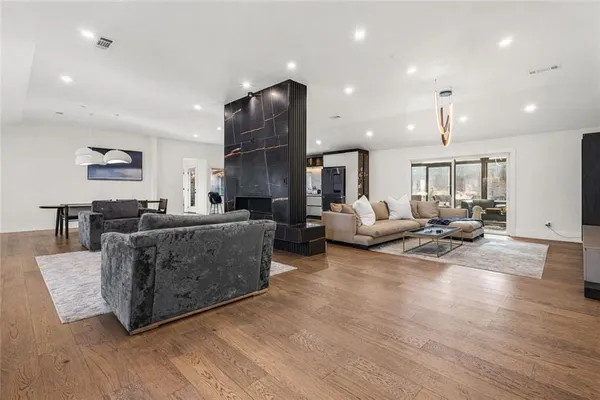 a living room with furniture and a wooden floor