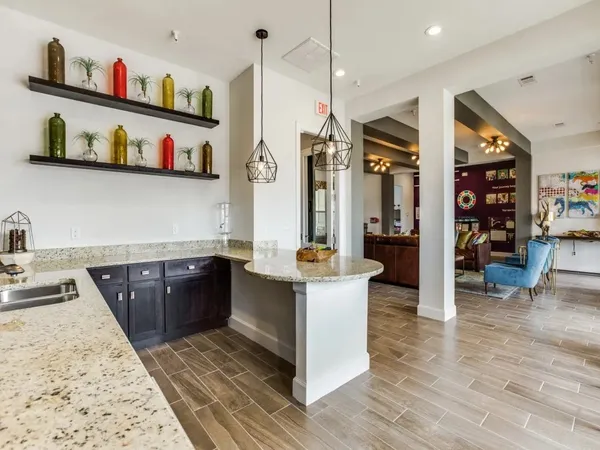 a kitchen with stainless steel appliances granite countertop a refrigerator and a wooden floors