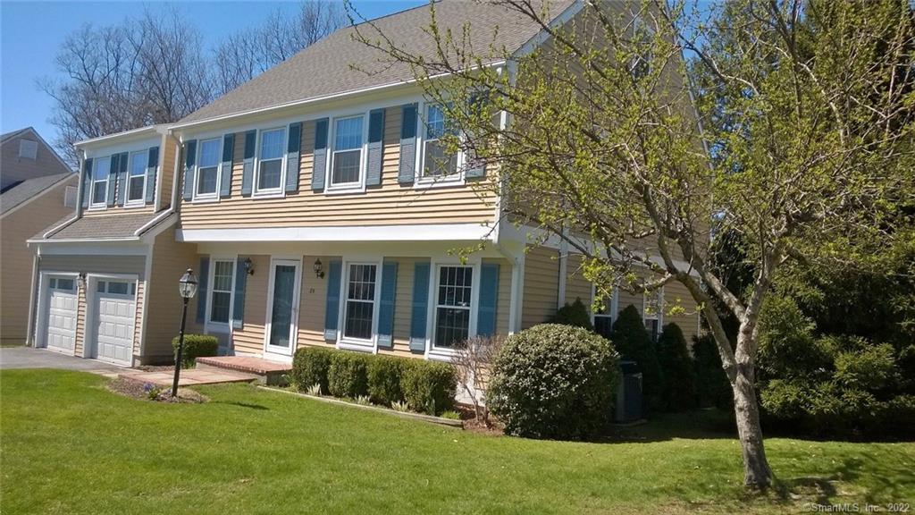 a view of a house with backyard garden and sitting area