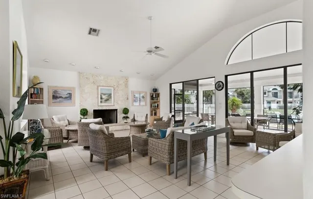 a living room with furniture large window and flat screen tv