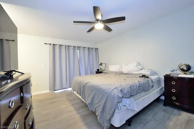 a bedroom with a bed and a ceiling fan