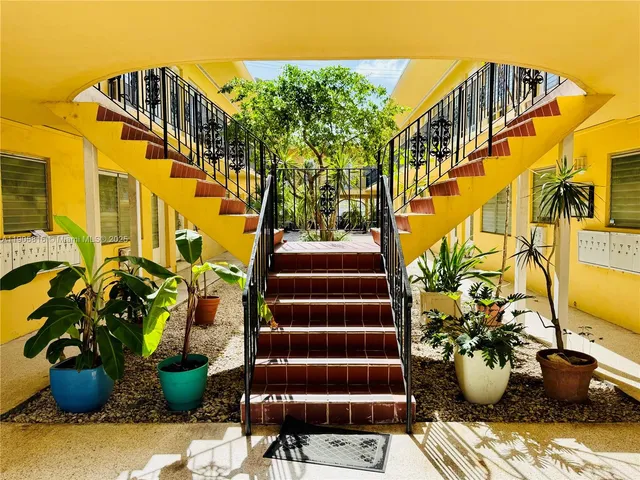 a view of a fountain with potted plants