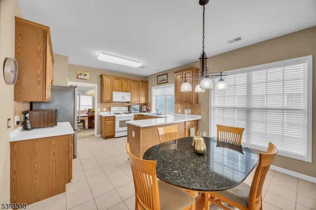 a kitchen with granite countertop a sink a counter top space and living room view