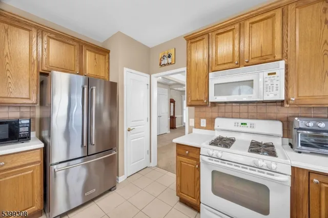 a kitchen with a refrigerator stove and sink