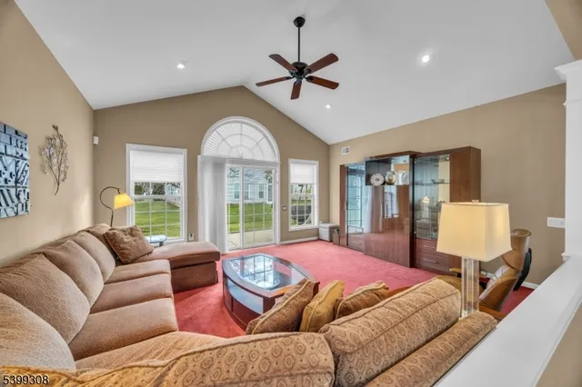 a living room with furniture a fireplace and a large window