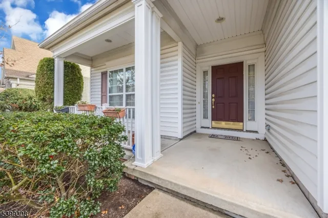 a view of small house with potted plants