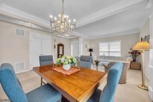 a view of a dining room with furniture and chandelier