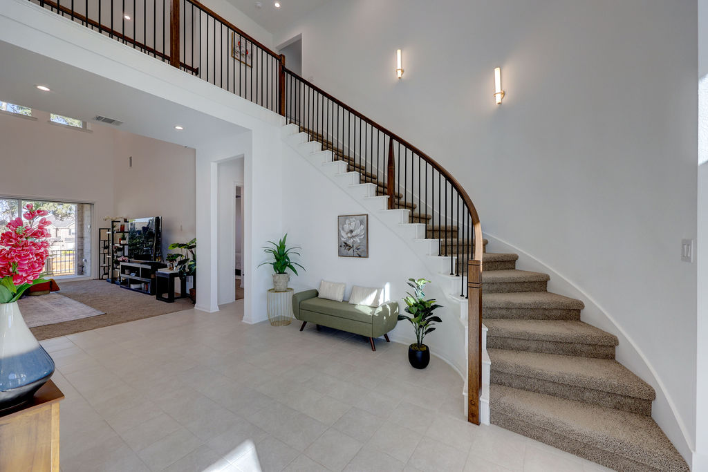 351 Pigeon River Road Kyle, TX 78640 - Photo 9 of 40 Staircase with a towering ceiling and recessed lighting