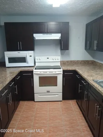 a kitchen with a stove and a sink