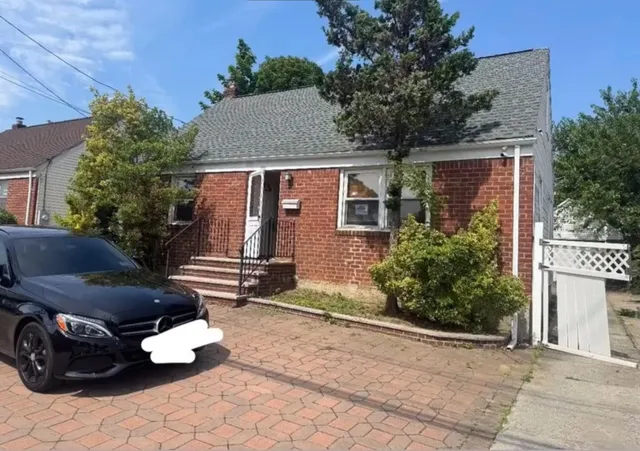 a front view of a house with parking