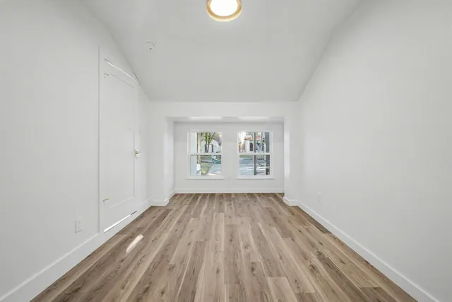 a view of a kitchen from a hallway