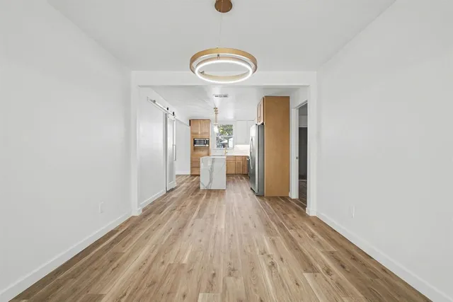 a view of a kitchen with a sink and a refrigerator