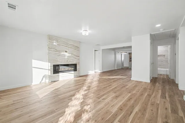 a view of room with wooden floor and natural light