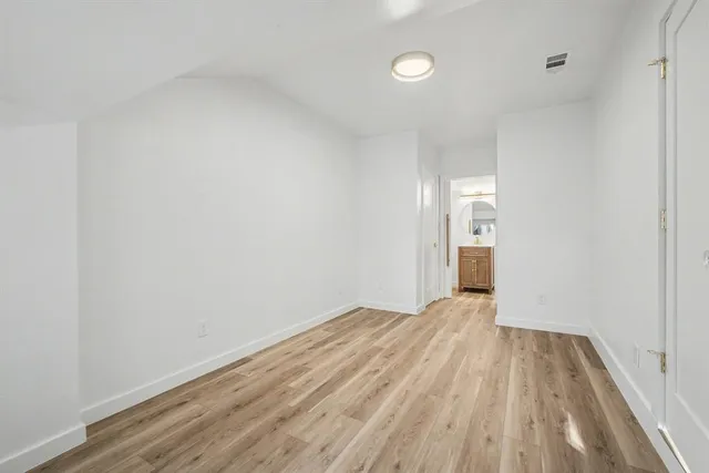 a view of hallway with wooden floor