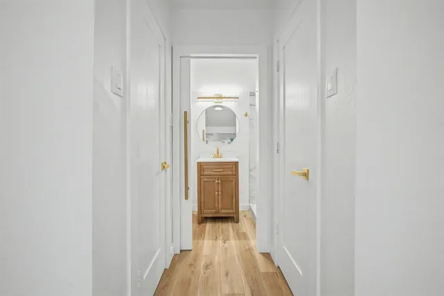 a bathroom with a sink vanity and a mirror