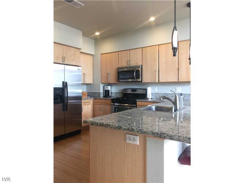 398 State Street, Unit 1 Reno, NV 89501 - Photo 3 of 6 a kitchen with stainless steel appliances granite countertop a refrigerator a stove top oven a sink and dishwasher
