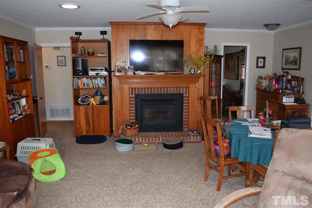 6908 Justice Drive Raleigh, NC 27615 - Photo 12 of 15 Combination family room and dining area. Full fireplace.