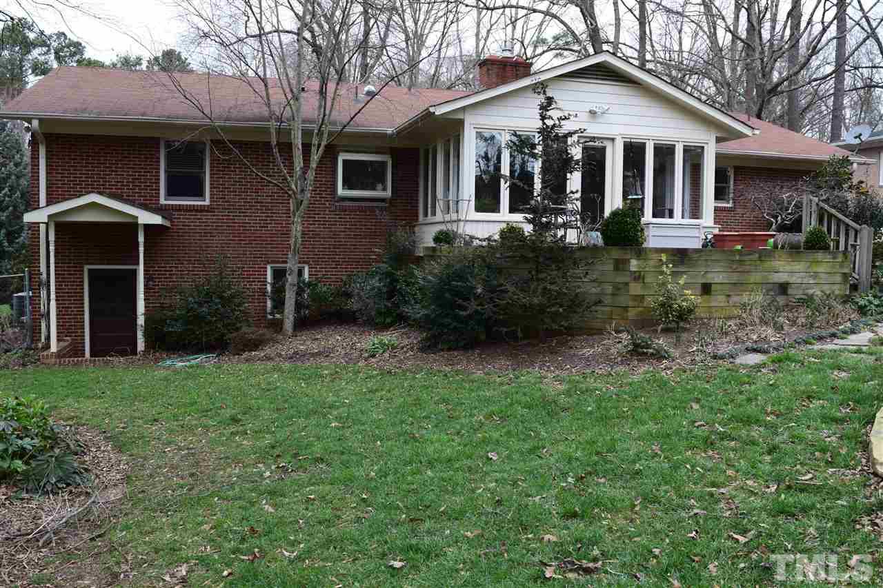 6908 Justice Drive Raleigh, NC 27615 - Photo 3 of 15 Rear of home that shows sun room and basement exterior door.