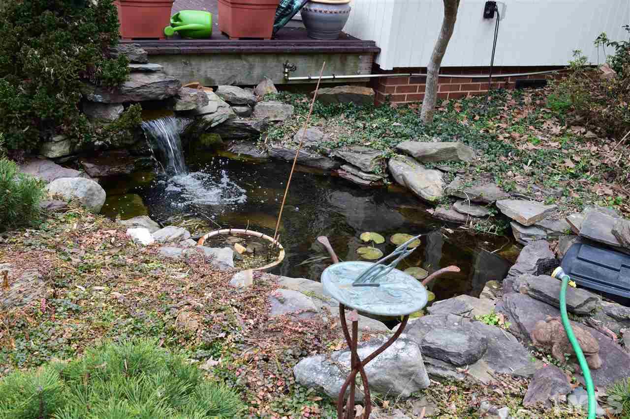 6908 Justice Drive Raleigh, NC 27615 - Photo 6 of 15 Landscape pond near sun room. You can hear running water in the family room.